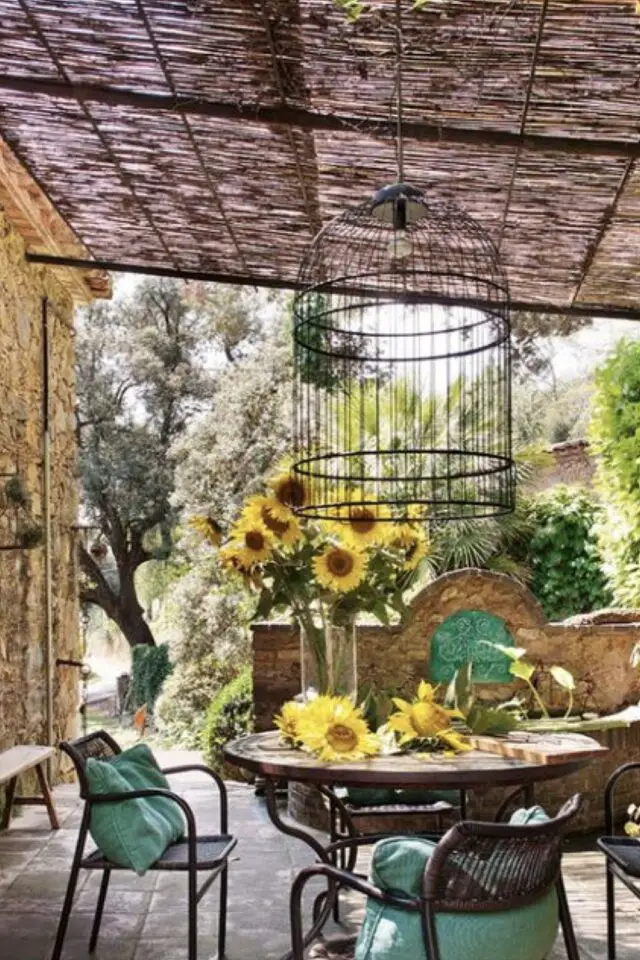 terrasse couverte moderne exemple petite table ronde fauteuil de jardin osier tressé cage à oiseau transformé en luminaire 