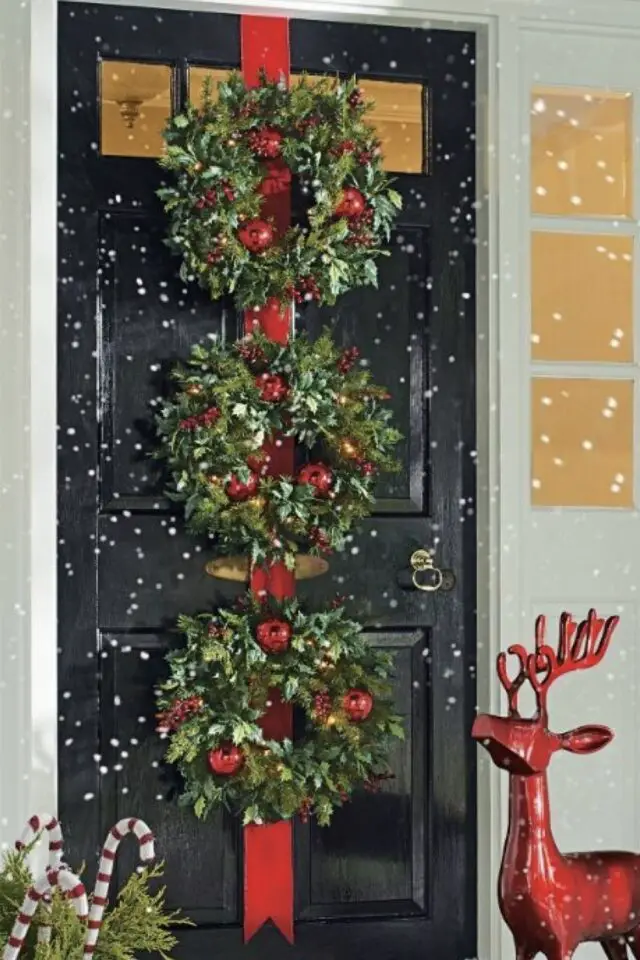 décoration extérieure noël exemple porte d'entrée couronnes sapin et boules rouge cerf ruban 